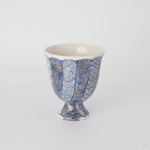 A smooth, 360-degree rotational video of the Kintsugi vessel. As it turns, you can follow the continuous flow of the luminous 24k gold lines as they wrap around the entire piece, revealing the artwork in its full three-dimensional form.