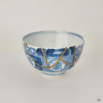Rotating view of a Ko-Imari sake cup in blue and white sometsuke porcelain with 24K gold kintsugi seams, turning to show the full restoration.