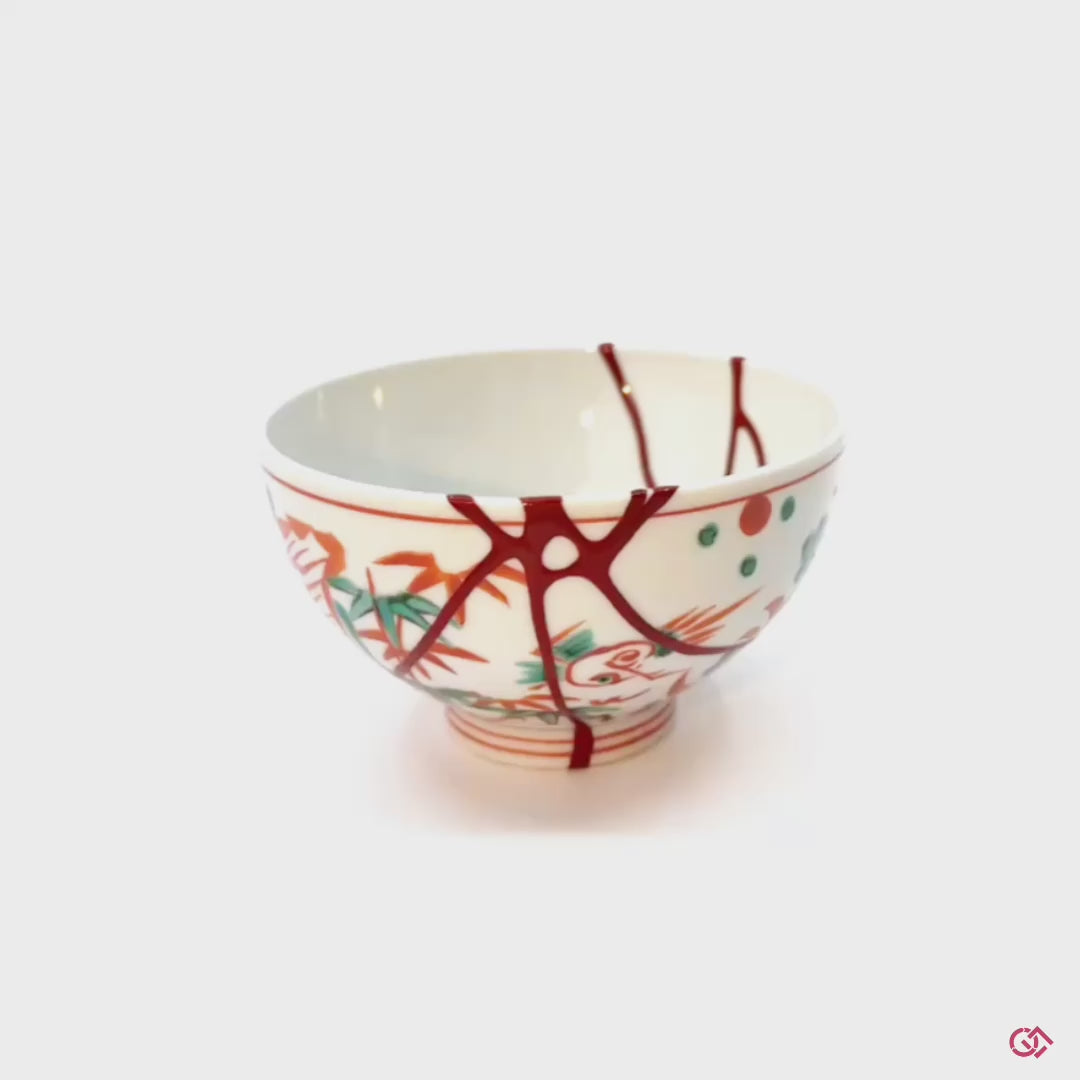 Discover the magic of Kintsugi: Watch a rotating video showcasing the beauty of repaired pottery.