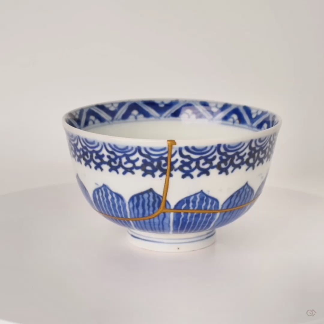 360-degree rotation of kintsugi Ko-Imari bowl, gold seams catching light across sometsuke porcelain, timeless elegance in motion.