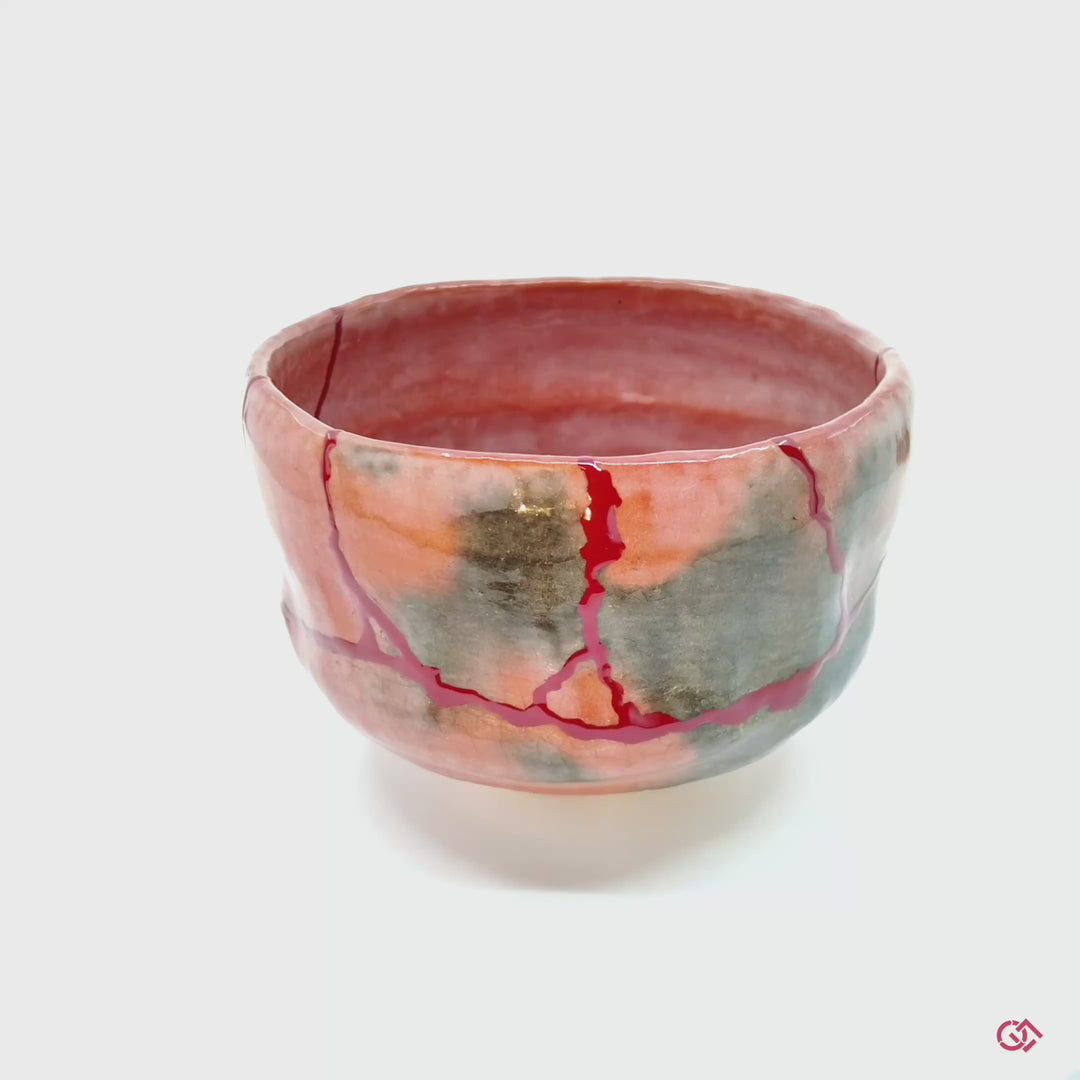 Discover the magic of Kintsugi: Watch a rotating video showcasing the beauty of repaired pottery.