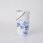 Rotating view of a kintsugi sake cup in thin Arita sometsuke porcelain, restored with natural urushi and finished in 24K gold, turning to show the full seam.