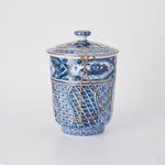 Rotation video of a kintsugi lidded tea cup in Kyoto ware, urushi and 24K gold seams crossing the shonzui panels and sansui band.