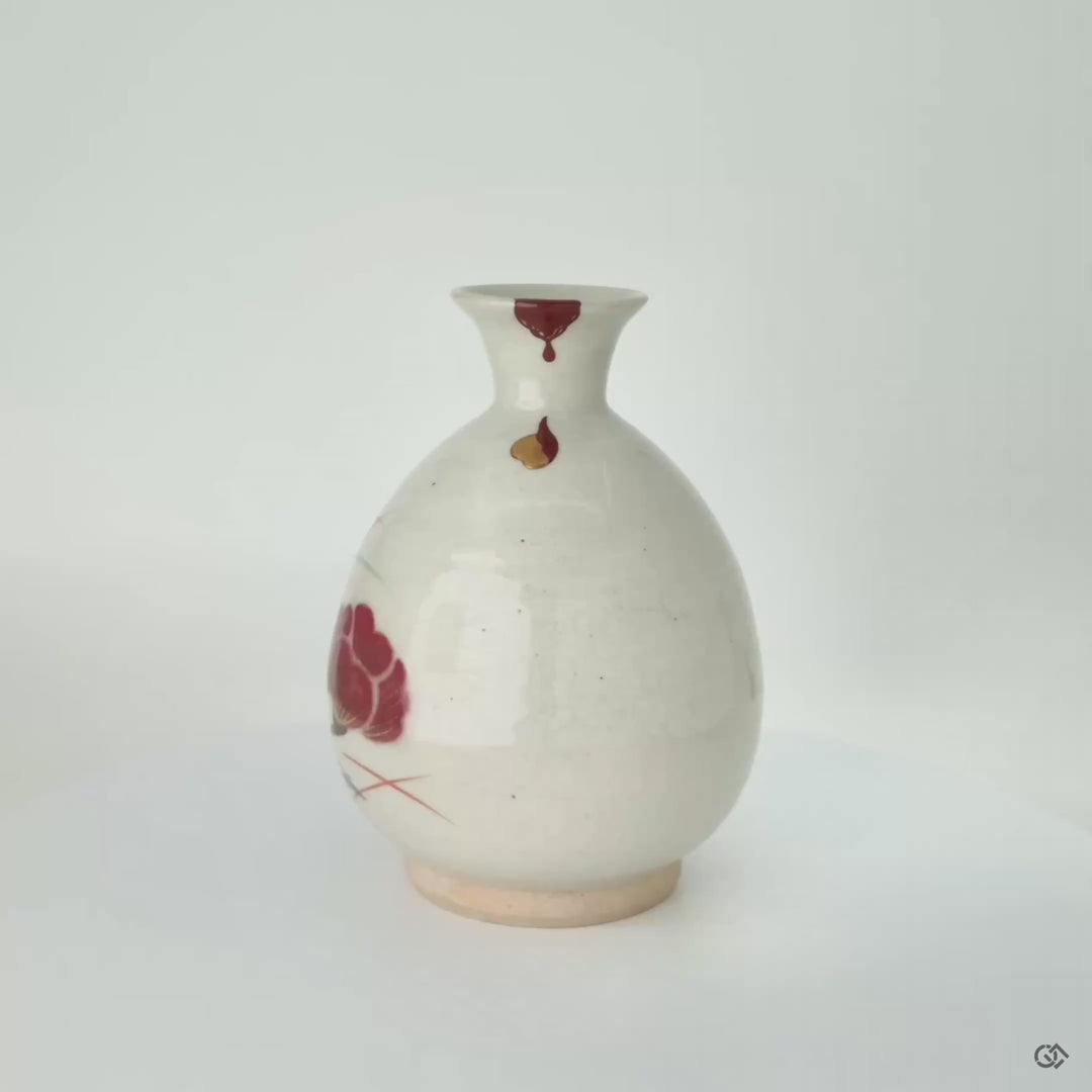 360° view of kintsugi tokkuri with vermilion urushi and gold droplets, revealing beauty in imperfection.