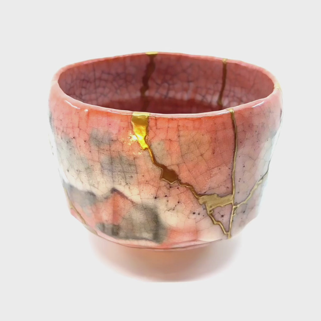 Discover the magic of Kintsugi: Watch a rotating video showcasing the beauty of repaired pottery.