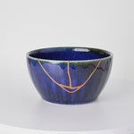 Rotation video of a Japanese kintsugi bowl in Mino ware, the urushi and 24K gold seam crossing the starry kamahen glaze and green rim.
