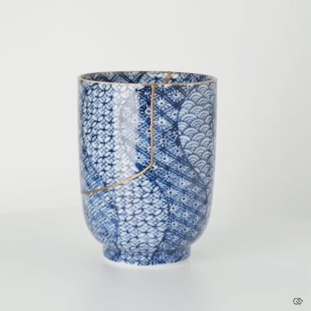Rotating view of a Kyoto tea cup with kintsugi seams visible from all angles, a treasured heirloom in motion.