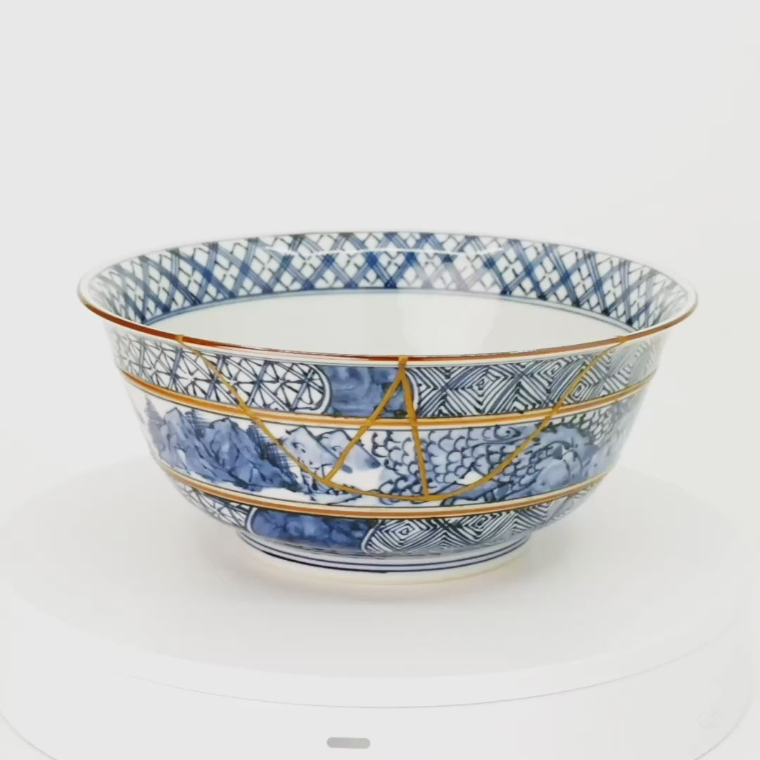 Rotation video of the Kyoto ware kintsugi serving bowl, the branching 24K gold seam moving across hand-painted sometsuke bands as the vessel turns.