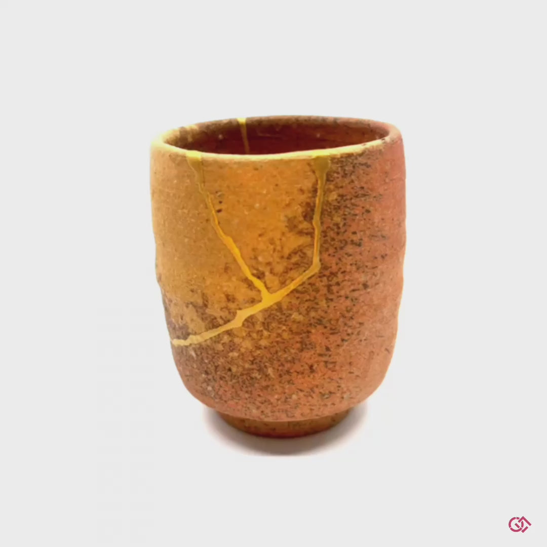 Discover the magic of Kintsugi: Watch a rotating video showcasing the beauty of repaired pottery.