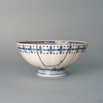 Front view of a kintsugi Kyoto ware rice bowl in white porcelain, sometsuke blue bands and 24K gold seams, a quiet beauty held in everyday form.