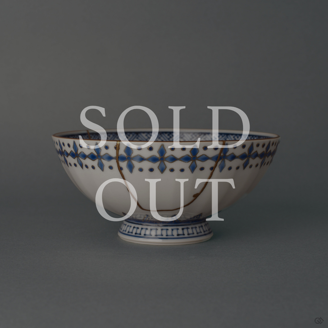 Sold out: kintsugi Kyoto ware rice bowl with sometsuke blue bands and 24K gold seams, restored in natural urushi lacquer.