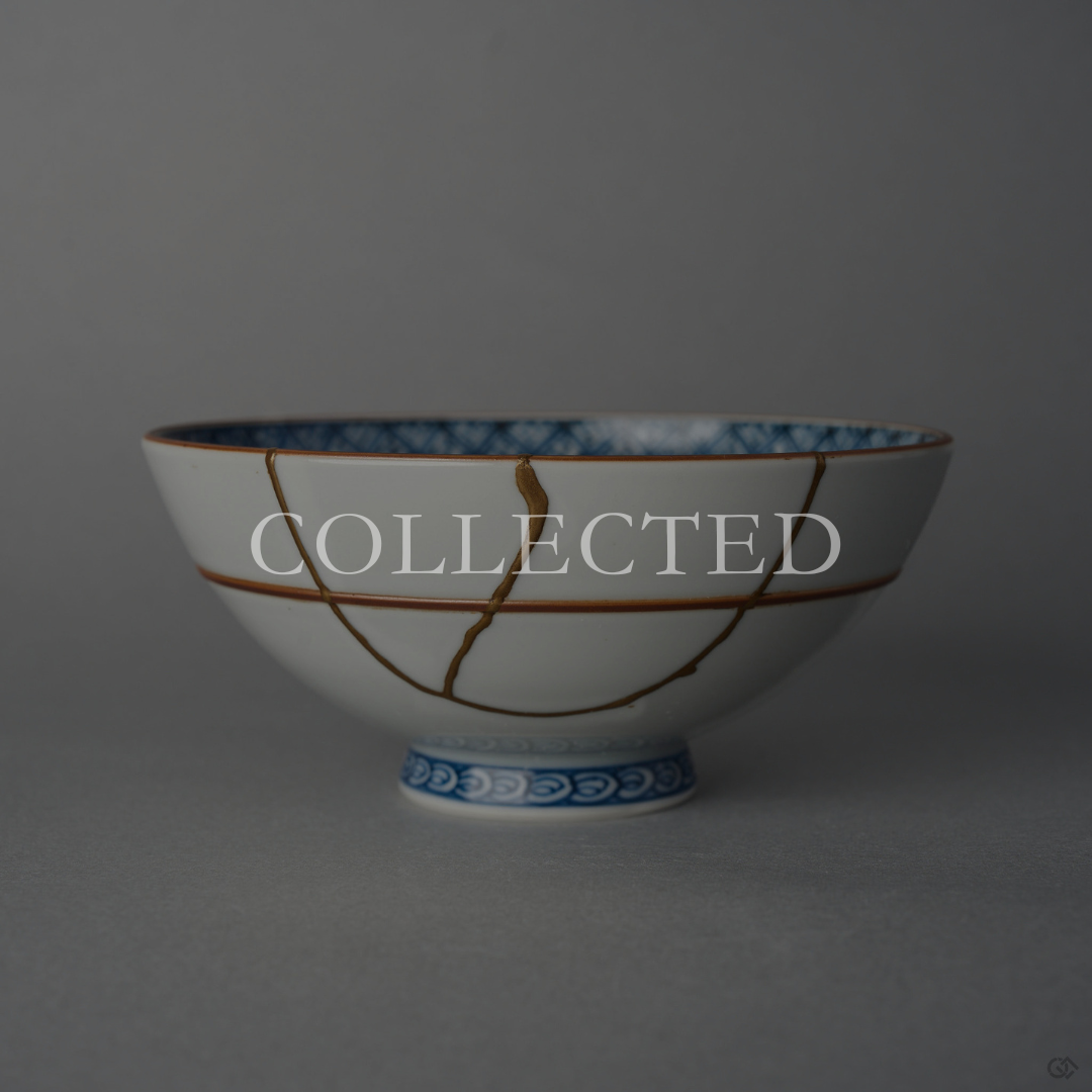 Kyoto ware white porcelain rice bowl with cobalt lattice rim and red accent lines, restored with a branching 24K gold kintsugi seam in natural urushi. Collected.