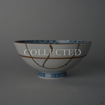 Kyoto ware white porcelain rice bowl with cobalt lattice rim and red accent lines, restored with a branching 24K gold kintsugi seam in natural urushi. Collected.