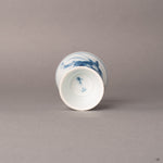 Bottom of a kintsugi Ko-Imari sake cup showing foot ring and gold restoration line, patina of time.