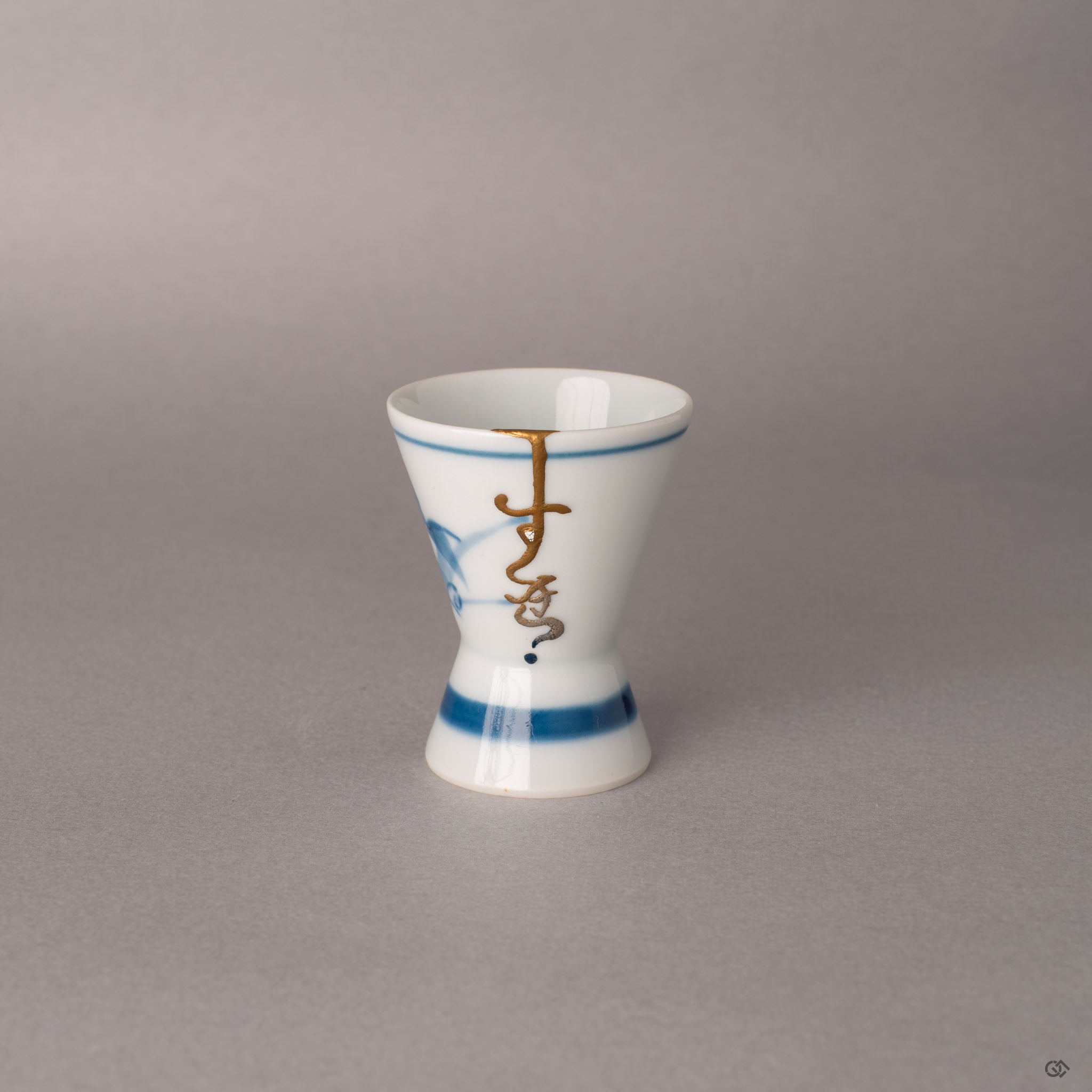 Kintsugi Ko-Imari sake cup with cobalt blue bands and 24K gold seam, eggshell rankaku inlay on white porcelain, a quiet beauty.