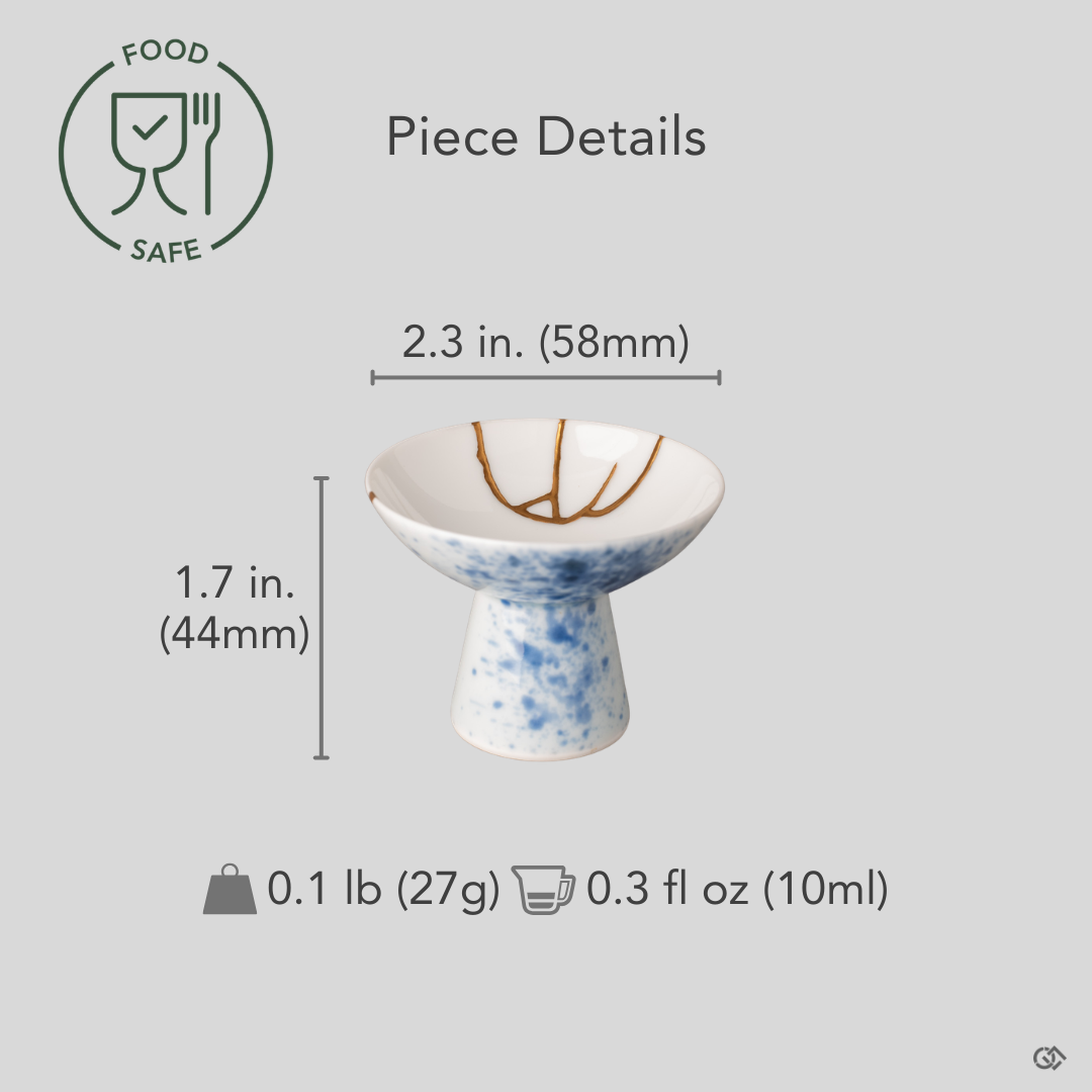 Kintsugi Arita sake cup with diameter, height, and weight measurements overlaid on the front view, gold seams visible across blue splatter glaze.