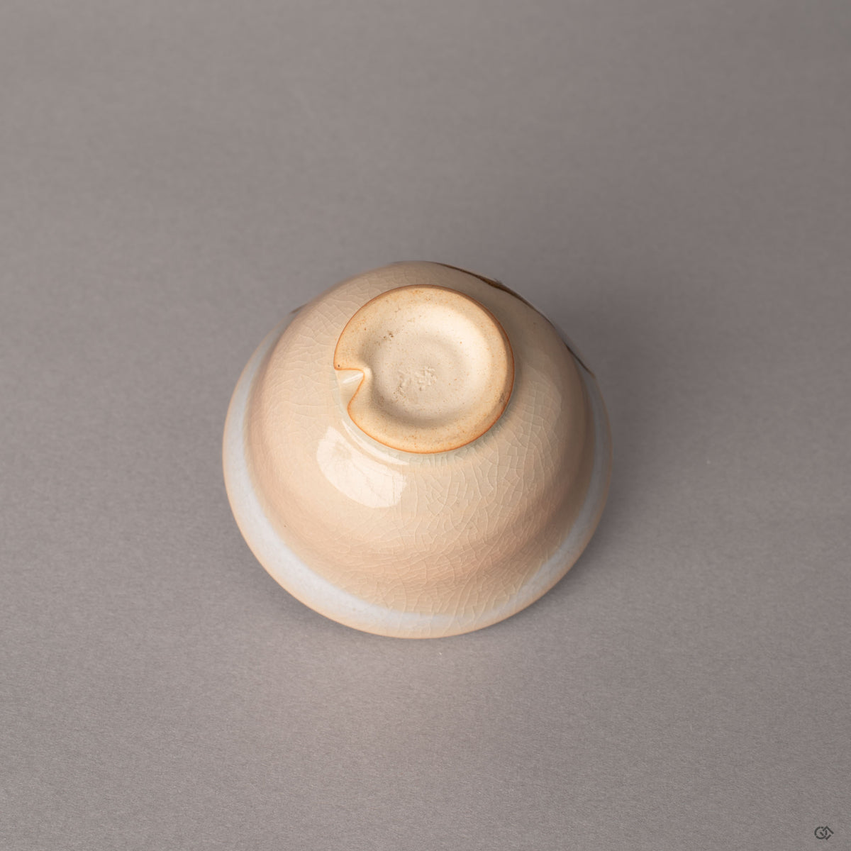 The kiriko-dai cut foot of this Hagi kintsugi cup rests beneath kannyu crackle glaze, a mark treasured by tea masters.