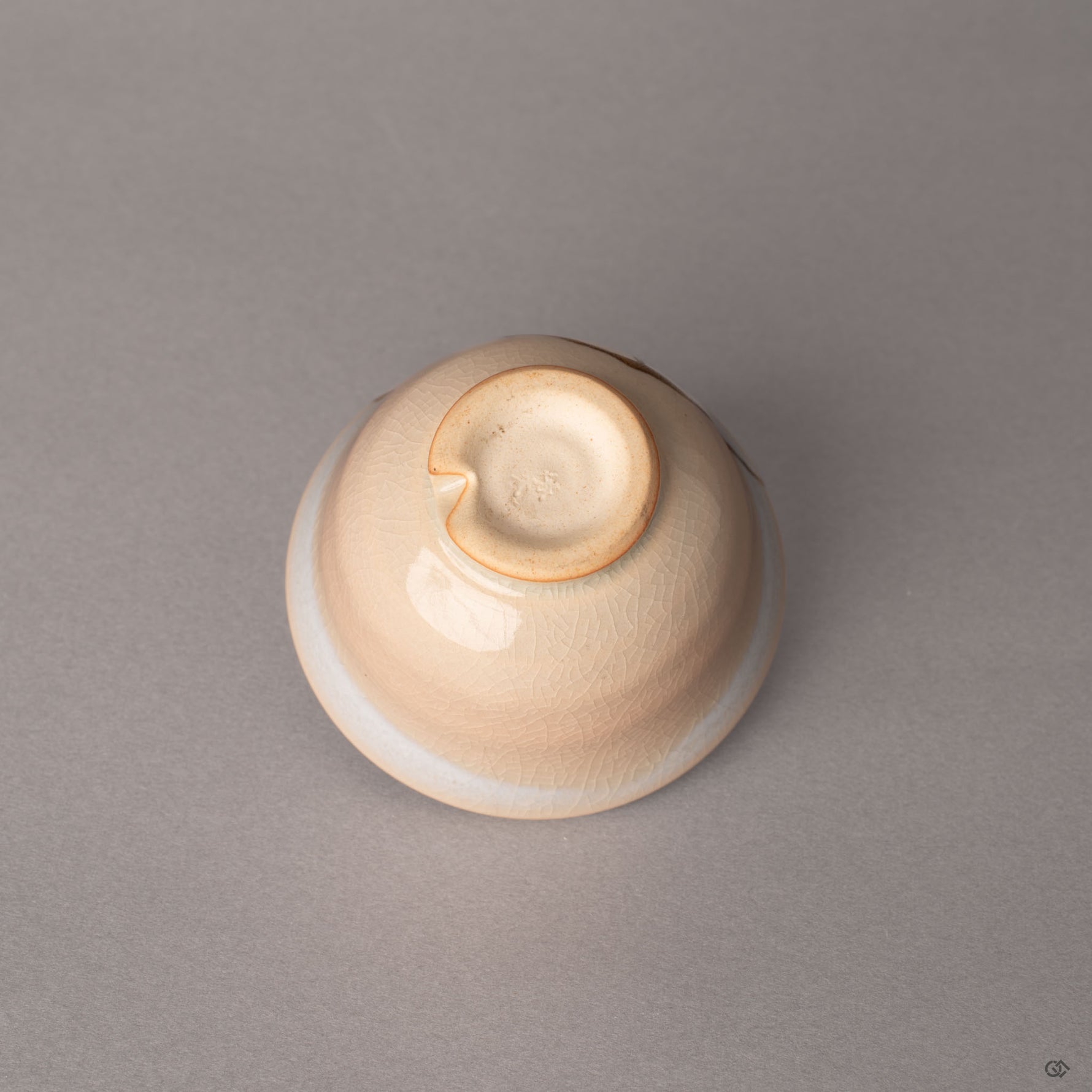The kiriko-dai cut foot of this Hagi kintsugi cup rests beneath kannyu crackle glaze, a mark treasured by tea masters.