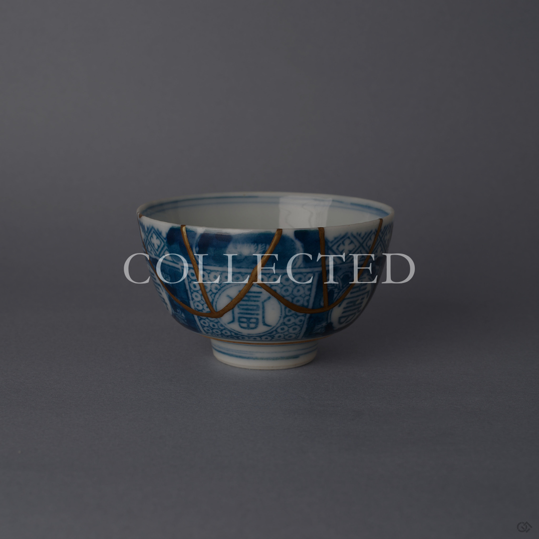 Ko-Imari sake cup in blue and white sometsuke porcelain with 24K gold kintsugi seams arcing down from the rim, restored with natural urushi in Japan. Sold out.