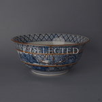 Kyoto ware porcelain serving bowl painted in sometsuke blue, its branching 24K gold kintsugi seam descending from the rim across banded patterns. Sold out.