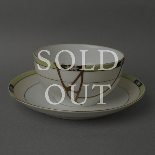 Sold out — An Art Deco Early Noritake cup and saucer with hand-painted florals, restored with authentic 24K gold kintsugi and natural urushi lacquer. This one-of-a-kind piece by The Kintsugi Labo JAPAN has found its home.