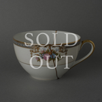Sold out: 24K gold kintsugi Early Noritake tea cup, pre-war white porcelain with hand-painted floral motifs, restored with natural urushi lacquer.