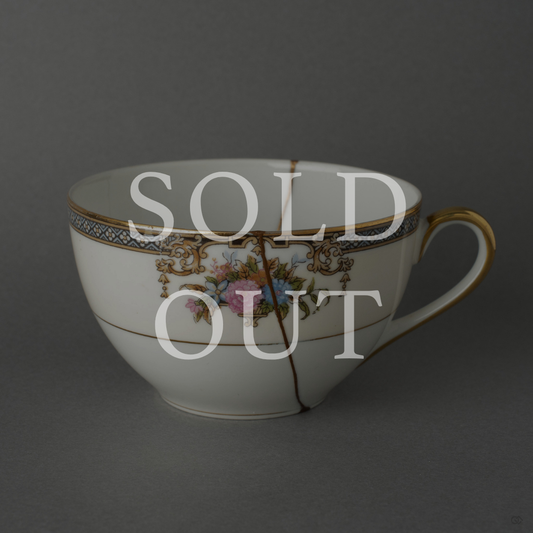 Sold out: 24K gold kintsugi Early Noritake tea cup, pre-war white porcelain with hand-painted floral motifs, restored with natural urushi lacquer.