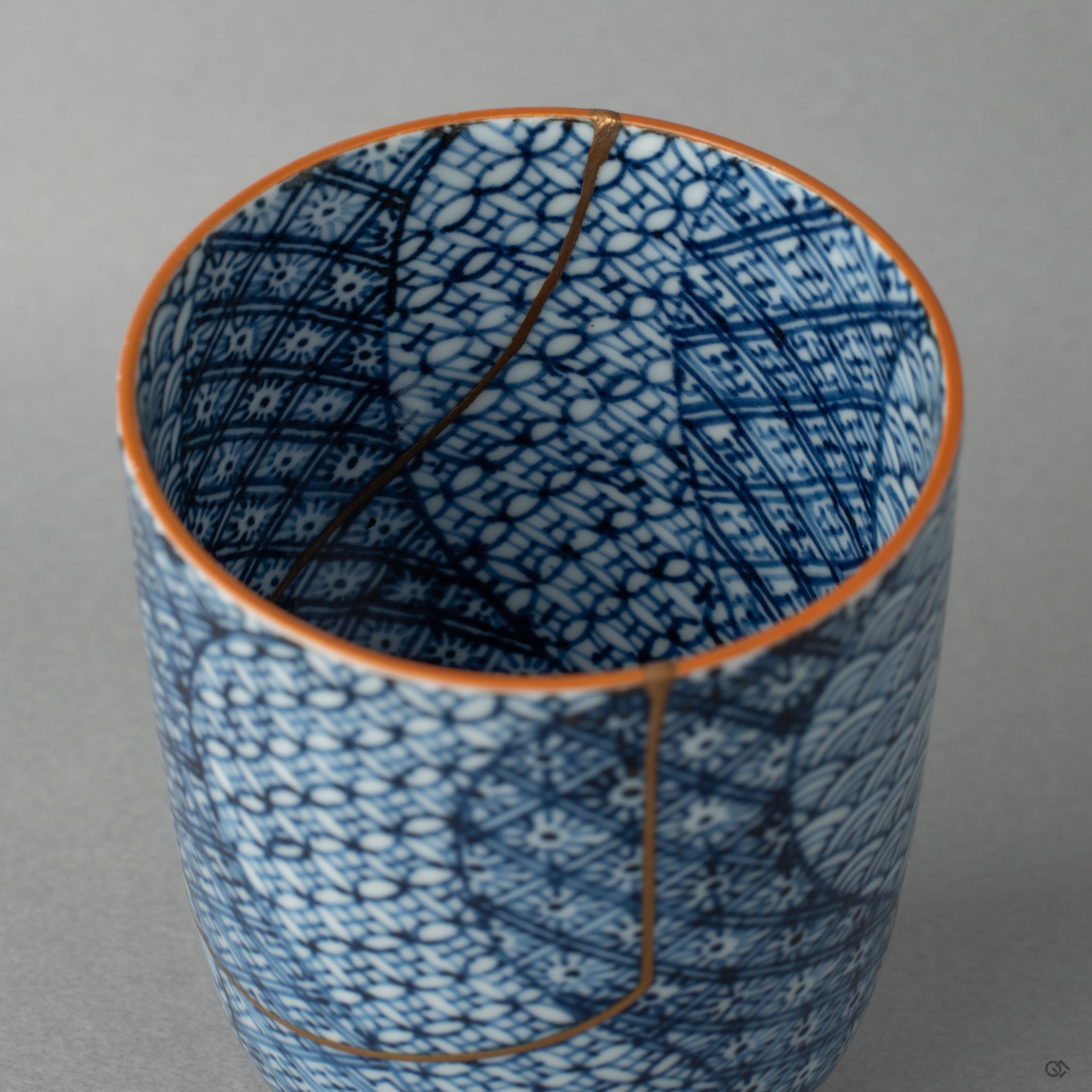 Detail of kintsugi lines inside a Kyoto tea cup, gold tracing the break with the patience of centuries-old tradition.