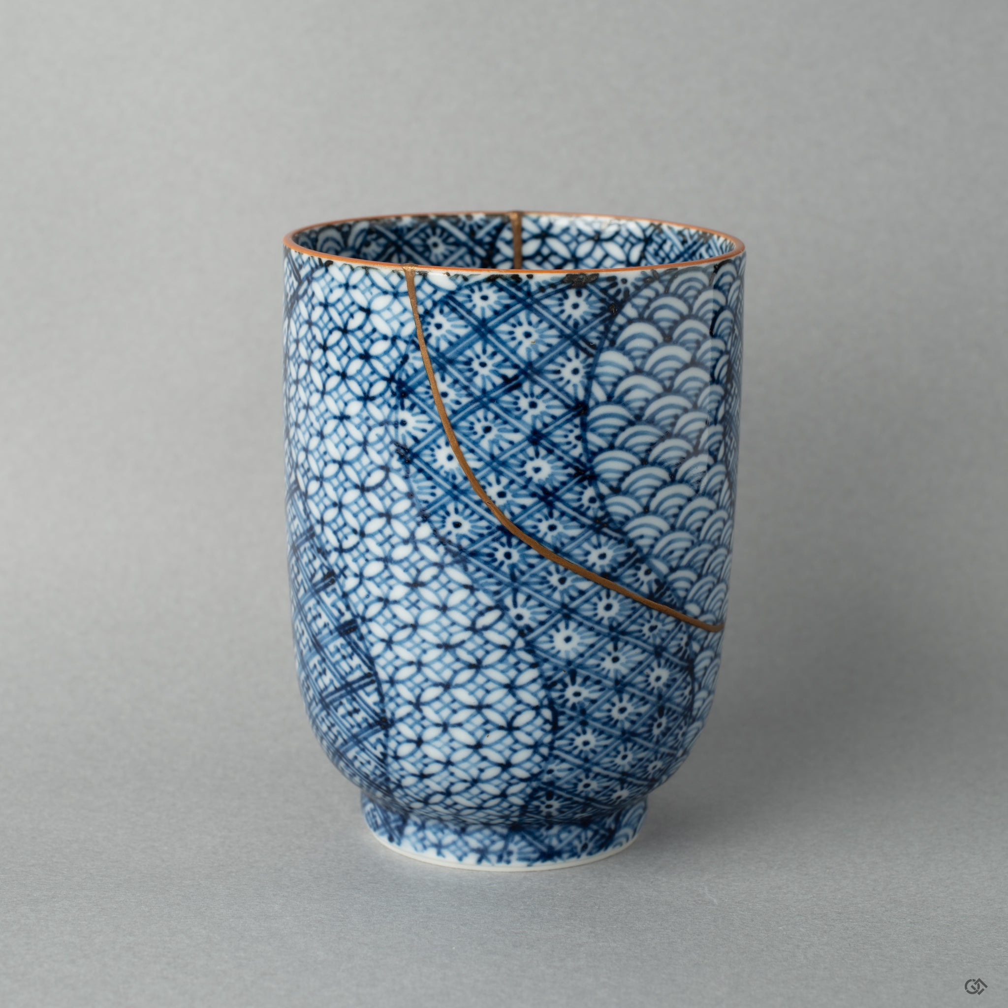 Side view of a Kyoto tea cup with gold kintsugi lines, each seam a story in every curve of this restored vessel.