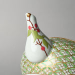 Close-up of the kintsugi restoration on the Kyoto teapot spout: the chip rebuilt with urushi, finished in 24K gold at the tip, and painted with nandina berries in urushi-e.