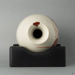 Top view of Kyoto ware tokkuri with vermilion kintsugi and gold droplet maki-e, honoring centuries-old tradition.