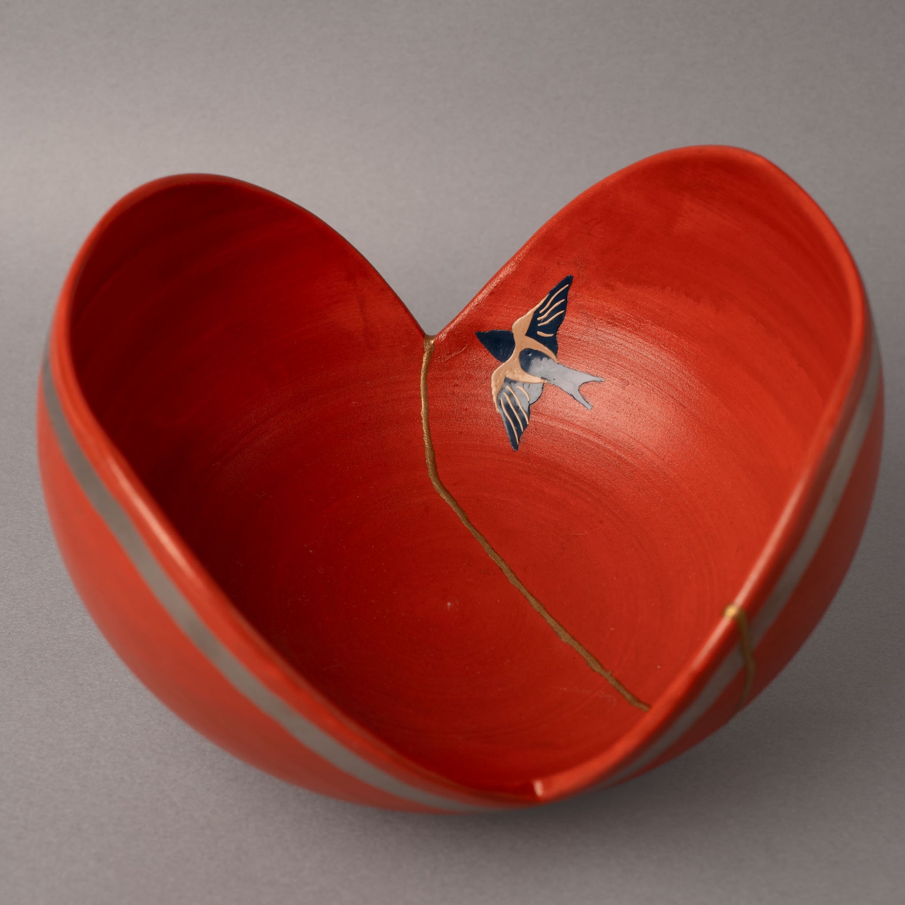 Urushi artist painting urushi-e swallow motif on a kintsugi-restored red bowl— kintsugi as urushi lacquer art beyond gold